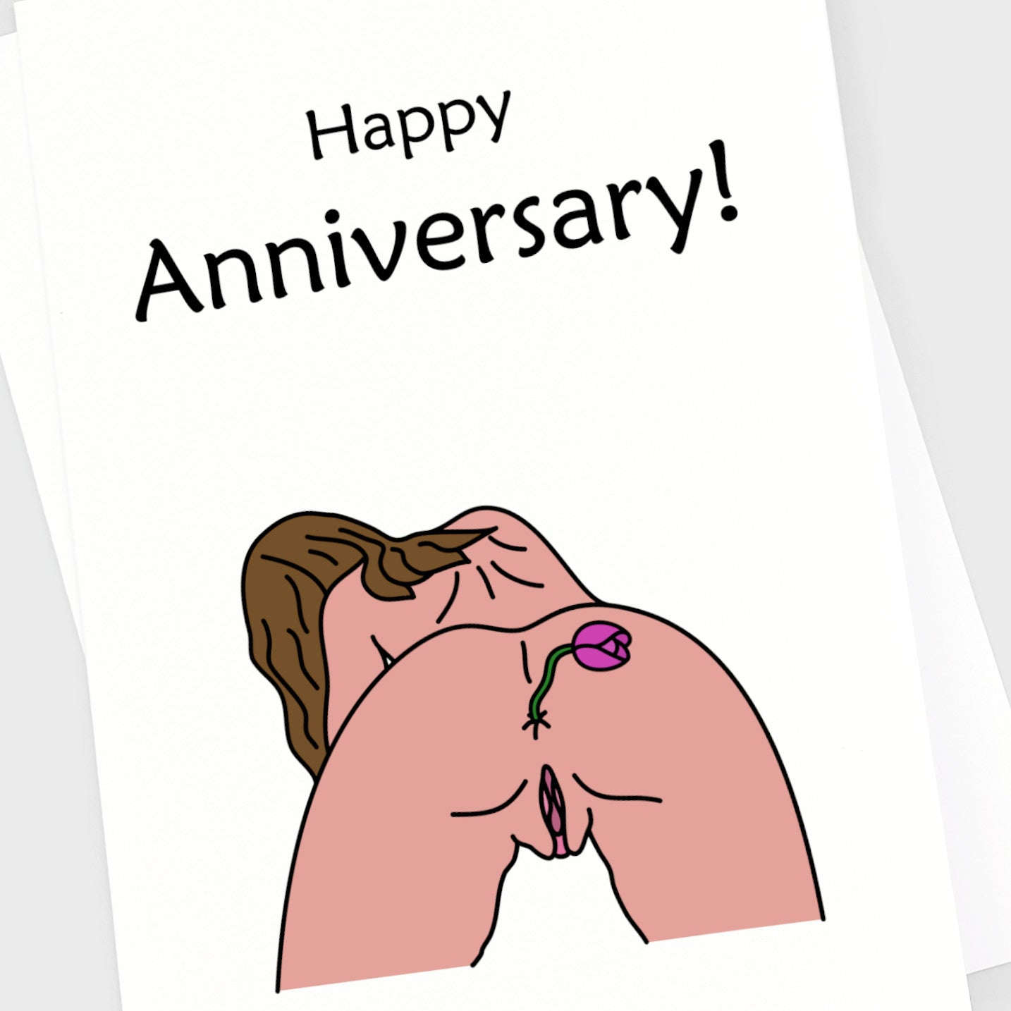 Close up of a rude anniversary card of a naked girl with a flower in her bum.
